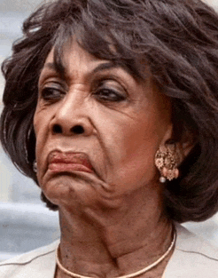 a woman wearing a necklace and earrings makes a funny face
