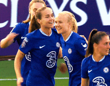 a group of female soccer players wearing blue jerseys with the number three on them