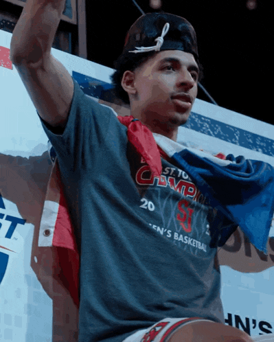 a man wearing a shirt that says ' champions ' on the front