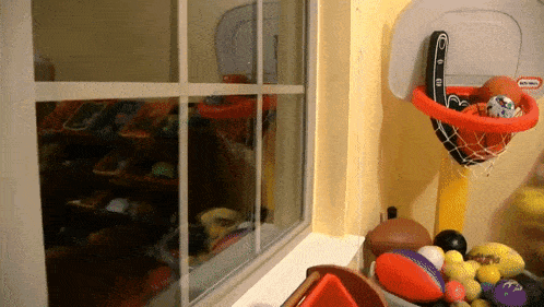 a little tikes basketball hoop filled with basketballs