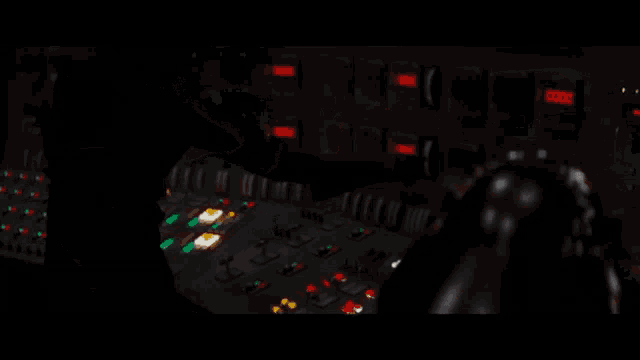 a person is pressing a button on a control panel