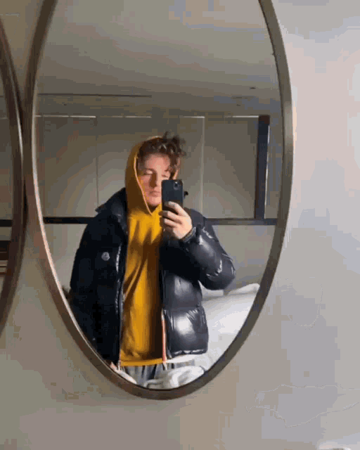 a person taking a selfie in a mirror with their phone