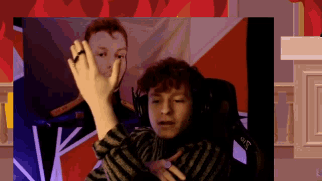 a man wearing headphones is giving a high five in front of a flag