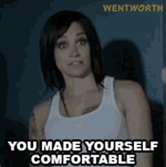 a woman in a white tank top with the words you made yourself comfortable