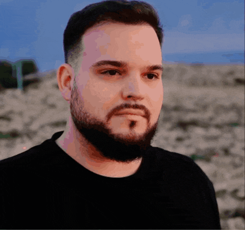 a man with a beard and mustache wearing a black shirt