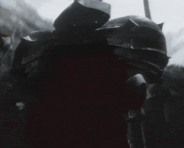 a man in armor with a red cape is standing in a crowd