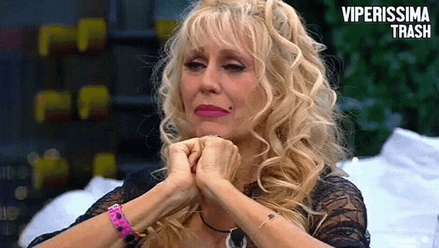 a woman with blonde hair and a bracelet that says ' viperissima trash '