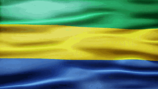 a blue yellow and green flag is being blown by the wind