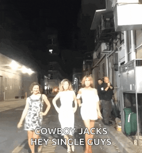 a group of women are walking down a street at night and the caption says cowboy jacks hey single guys