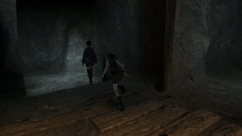 a person is hanging upside down in a dark cave