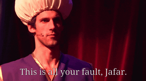 a man in a turban says " this is all your fault jafar " in front of a red curtain