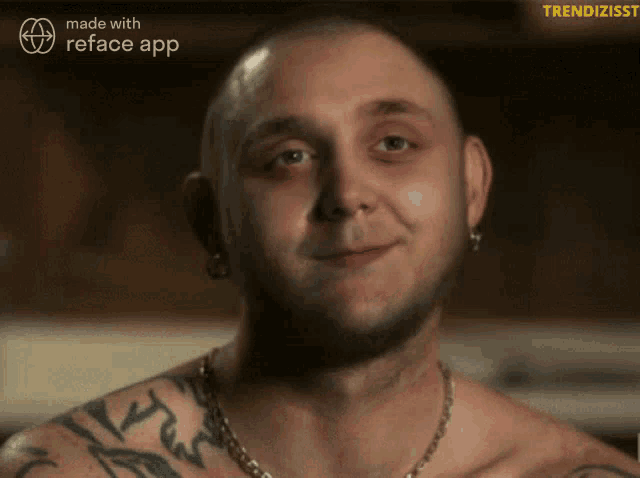 a man with a tattoo on his arm is smiling in a reface app video