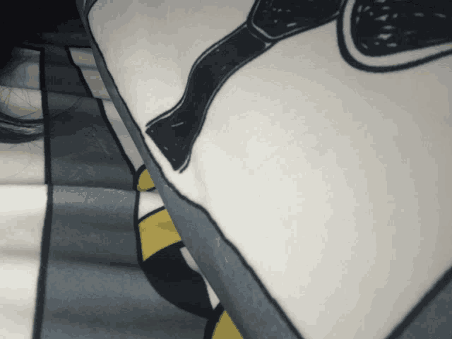 a close up of a blanket with a drawing of a man with a bow tie