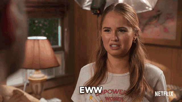 a woman wearing a t-shirt that says empower women says eww