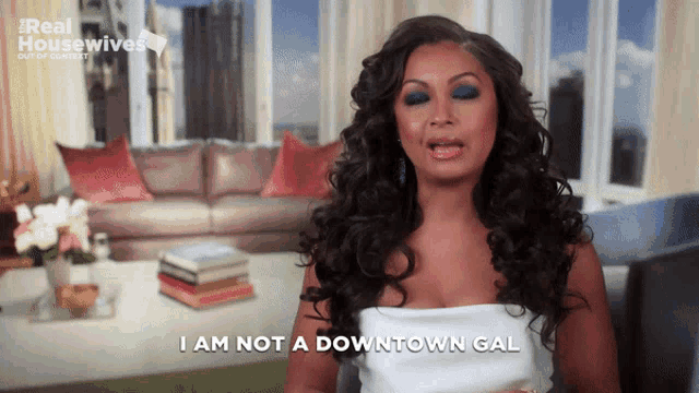 a woman says i am not a downtown gal in front of a living room