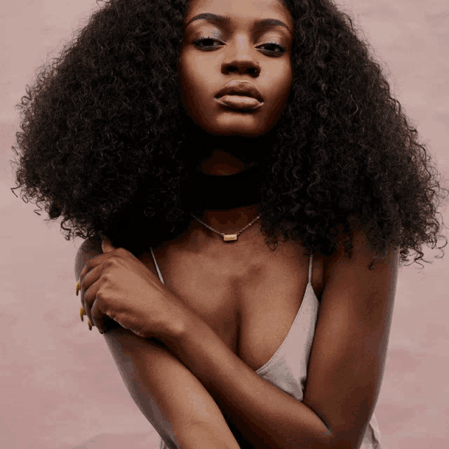 a woman with curly hair and a choker necklace