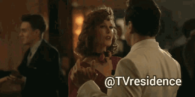 a man in a white suit is dancing with a woman in a black dress and the words @tvresidence are on the bottom right