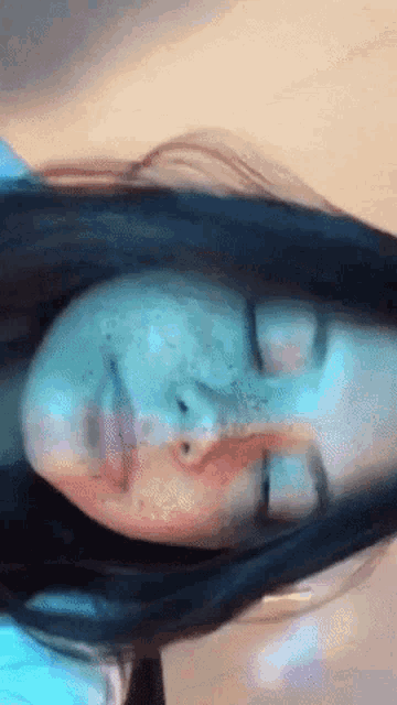 a close up of a woman 's face with her eyes closed and her mouth open