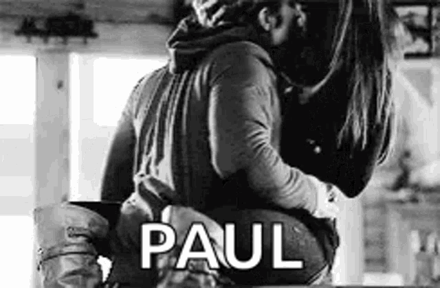 a man is carrying a woman on his back .