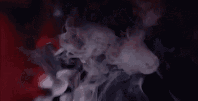 smoke is coming out of a bottle on a red and black background .