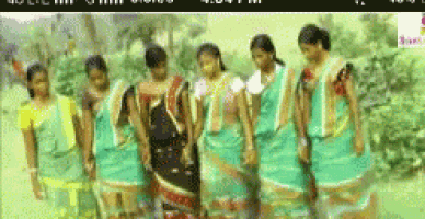a group of women standing next to each other in a field