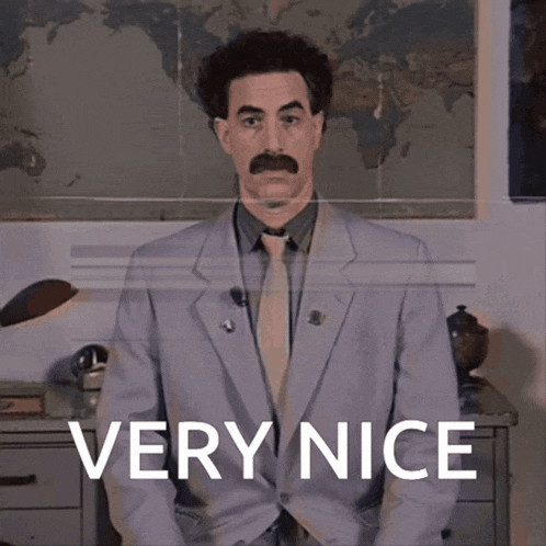 a man in a suit says very nice in front of a map