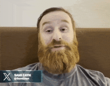 a man with a beard has the name sami zayn written on his shirt