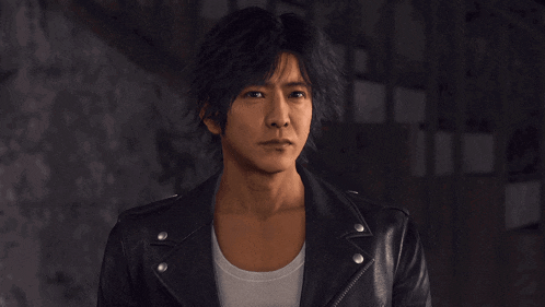 a man wearing a black leather jacket and white shirt