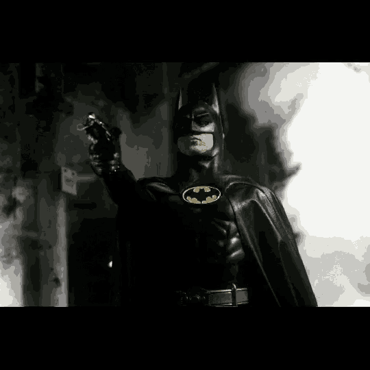 a man in a batman costume holding a gun
