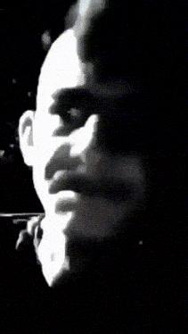 a blurry picture of a man 's face with a blue background