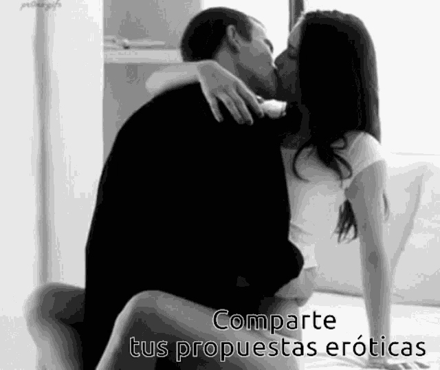 a black and white photo of a man and woman kissing with the words comparte tus propuestas eroticas below them