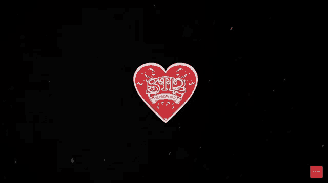 a red heart with the letters snp written on it