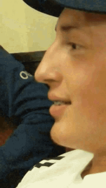 a close up of a man 's face with a hat on