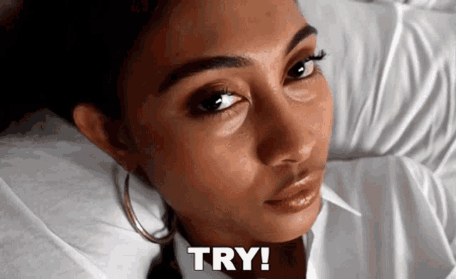 a close up of a woman 's face with the word try written below her