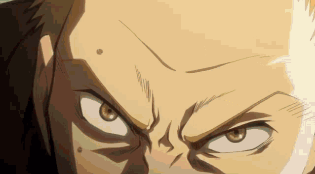 a close up of a man 's face with an angry look on his face
