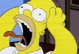 homer simpson is making a funny face with his mouth open and his tongue out .