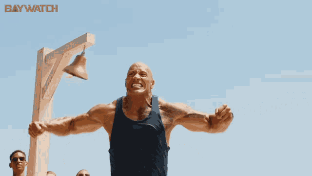 a man in a blue tank top is screaming in front of a baywatch sign