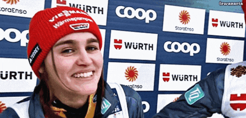 a woman wearing a red hat that says wurth coop