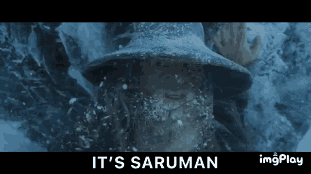 a man with a beard and hat is covered in snow and says it 's saruman on the bottom