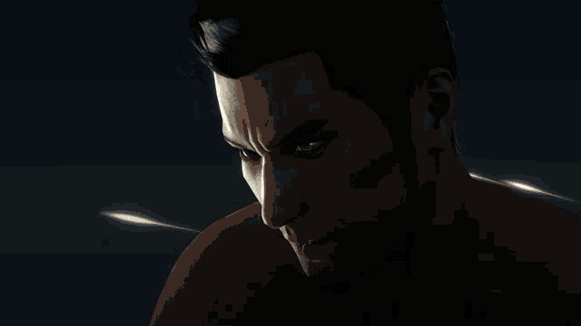 a close up of a man 's face in the dark with a few lights behind him