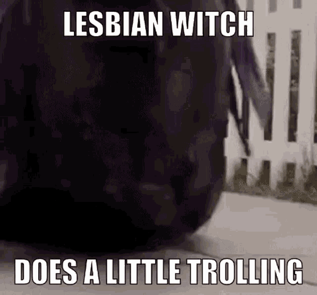 a lesbian witch is walking down a sidewalk with a backpack .