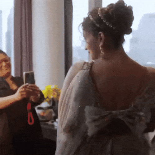 a woman taking a picture of herself in a mirror