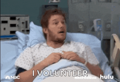 a man is laying in a hospital bed with his mouth open .