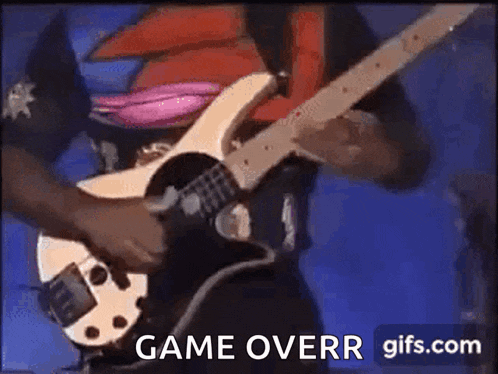 a man is playing a bass guitar on a stage and the words game overr are displayed on the screen .