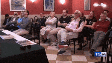 a group of people are sitting in front of a table that says media24