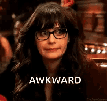 a woman wearing glasses is making a funny face and the word awkward is on the bottom of her face .