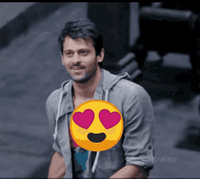 a man with hearts in his eyes and a smiley face behind him