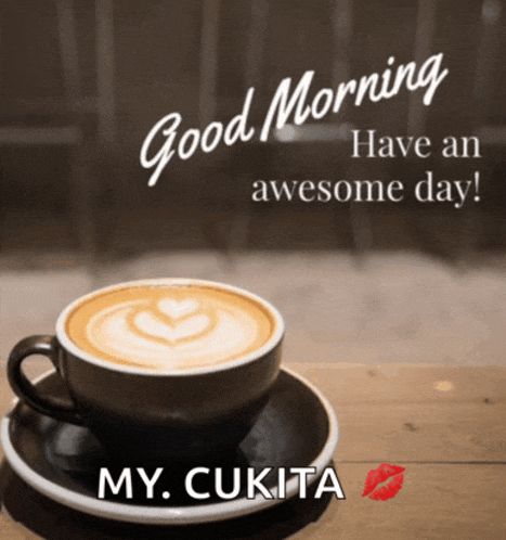 a cup of coffee on a saucer that says good morning