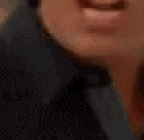 a close up of a man 's face with his mouth open and his teeth visible .
