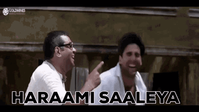 two men are laughing and pointing at each other while one of them says haraami saaleya .